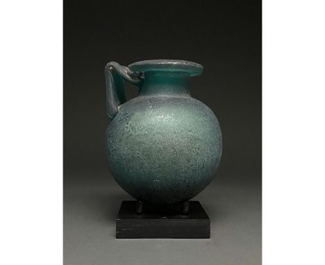 Possibly Grand Tour period. Roman-style greenish-blue glass vessel with an out-turned rim, cylindrical neck, globular body an