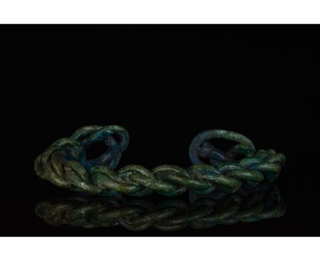 700-1100 AD, Viking Age. A heavy bronze twisted bracelet comprising several strands of bronze woven together with flattened l