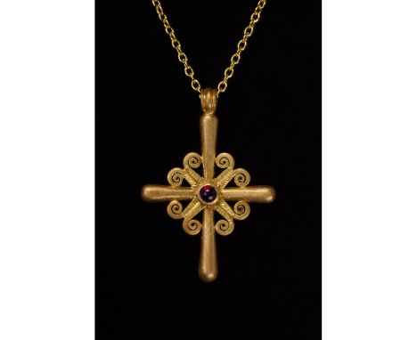 1100-1300 AD. Byzantine. Gold cross with four round-section arms of equal length set around a garnet cabochon; the space betw