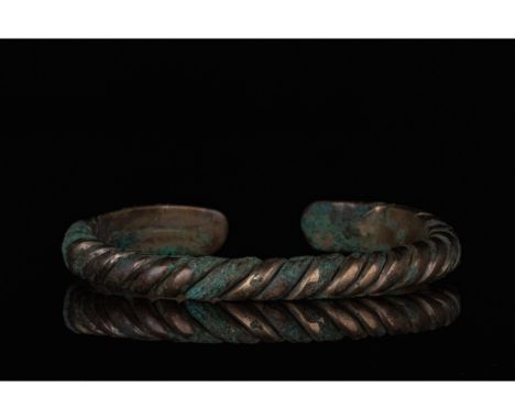 700-1100 AD, Viking Age. A heavy bronze twisted bracelet comprising several strands of bronze woven together with flattened l