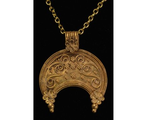 100-300 AD. Roman. Gold amulet with rounded ribbed suspension loop featuring rosette or star ornament, from which hands a cre