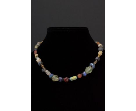 Ca. 100-300 AD. Roman. A restrung necklace of Roman beads comprising multiple opaque and transparent sub- spherical, tubular 