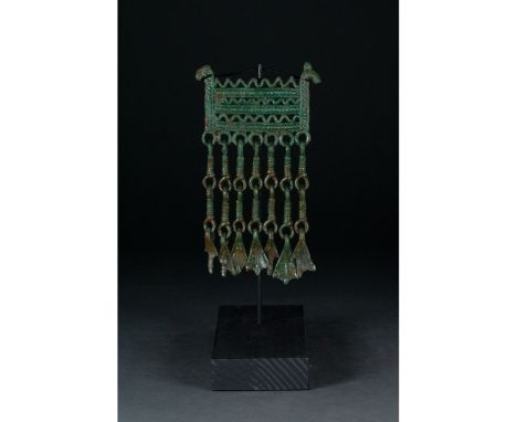 900-1100 AD. Viking Age. Bronze amulet comprising a longboat with stylised dragonâ€™s-head prow and stern with carefully cast