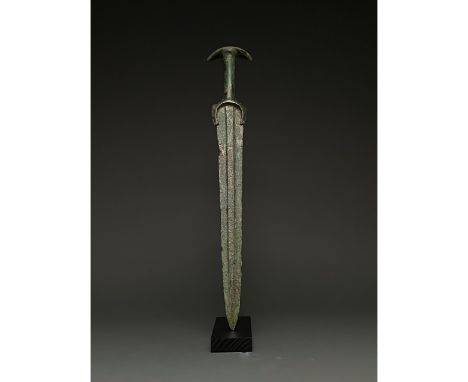 1200-700 BC, Greek Archaic Period. This beautiful bronze sword has a tapering, bevelled blade with raised midrib, an integral