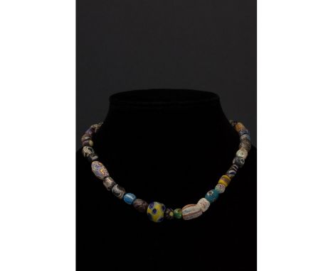 Ca. 100-300 AD. Roman. A restrung necklace of Roman millefiori glass beads of spherical and cylindrical form and made using a