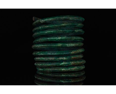 700-1100 AD, Viking Age. A heavy bronze coiled bracelet intended to evoke the form of a snake. In Viking society, arm rings a