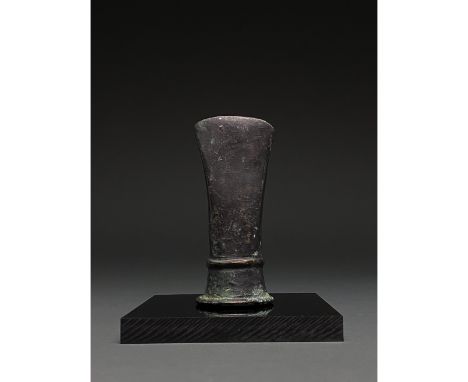 C. 1000-800 BC, Celtic Bronze Age. Bronze axe head with short curved blade, elongated, cylindrical cheek with a single rib ru