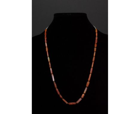 Ca. 100-300 AD. Roman. A restrung necklace of Roman beads comprising cylindrical carnelian beads and spherical metallic space