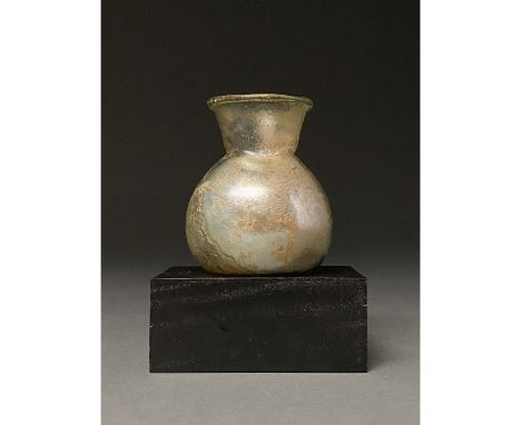 100-300 AD. Roman. Pale green glass flask with fold rim, inward sloping neck and globular body. Glass was a major manufacturi