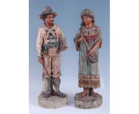 A large pair of early 20th century probably Austrian ceramic figures, modelled as male and female standing musicians, the lar