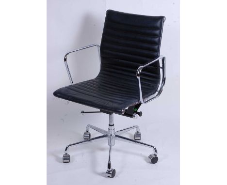 After Charles &amp; Ray Eames - a polished aluminium framed EA108 swivel desk chair, having black leather slung seat, raised 