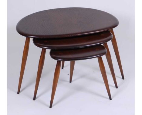 A 1960s Ercol dark elm nest of three 'pebble' occasional tables, each on turned tapering supports, the largest h.40cm, w.65cm