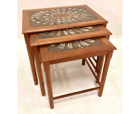 A 1960s Danish teak and tile-top inset nest of three occasional tables, raised on chamfered supports, the largest h.48cm, w.5