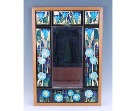A contemporary Moorcroft bevelled rectangular wall mirror, the tiled surround in the Entwined pattern, with plain light oak e