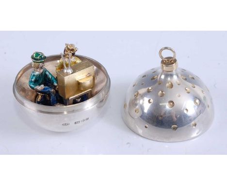 Stuart Devlin (1931-2018) - a silver and silver-gilt 'surprise' Christmas bauble, the removable cover revealing an interior w