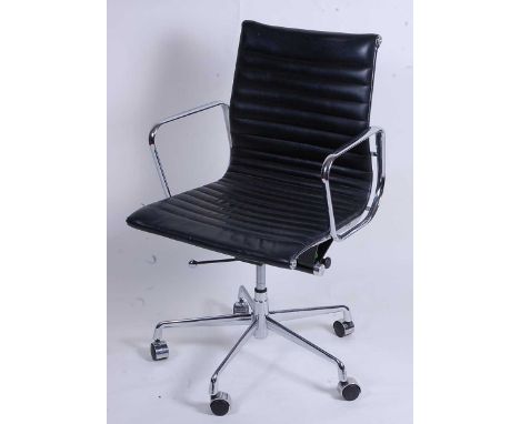 After Charles &amp; Ray Eames - a polished aluminium framed EA108 swivel desk chair, having black leather slung seat, raised 