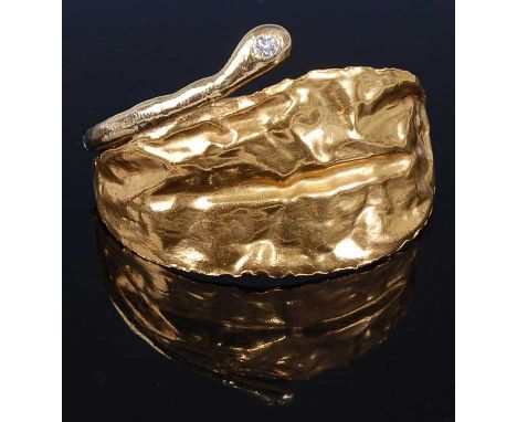 A 1970s 18 carat gold and single stone diamond set bangle, of naturalistic leaf form, with hinged safety catch, stamped 750, 