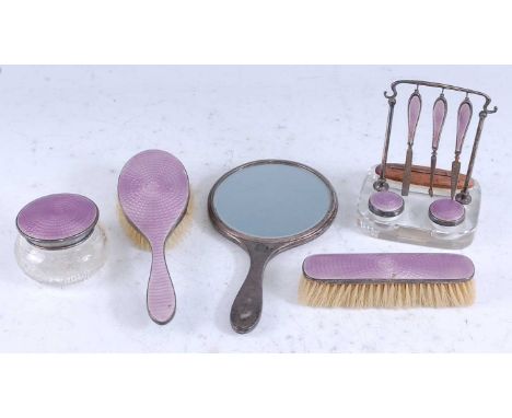 An Art Deco silver and purple guilloche enamel decorated dressing table set, comprising a vanity stand with nail files, buffe