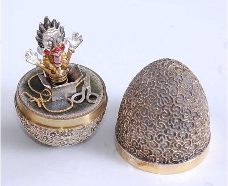 Stuart Devlin (1931-2018) - a 1980s silver-gilt 'surprise' egg, the outer body incise stylised decorated and enclosing a Jack