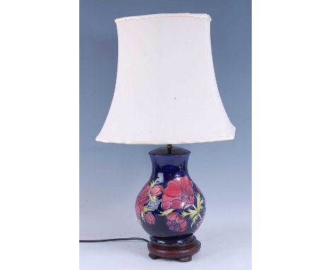 A contemporary Moorcroft Anemone pattern pottery table lamp, of bulbous form, raised on mounted turned wood stand, with shade