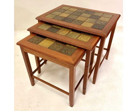 A 1960s Danish teak and tile-top inset nest of three occasional tables, raised on square slightly tapering supports, the larg