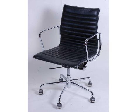 After Charles &amp; Ray Eames - a polished aluminium framed EA108 swivel desk chair, having black leather slung seat, raised 