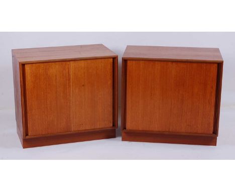 A pair of 1970s G-Plan teak low double door side cupboards, each with sliding doors and single interior shelf, w.76.5cm, h.71