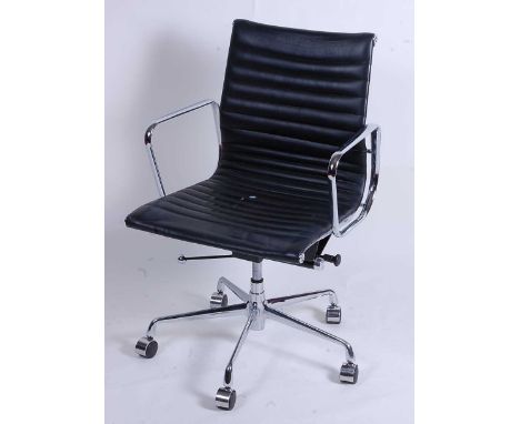 After Charles &amp; Ray Eames - a polished aluminium framed EA108 swivel desk chair, having black leather slung seat, raised 