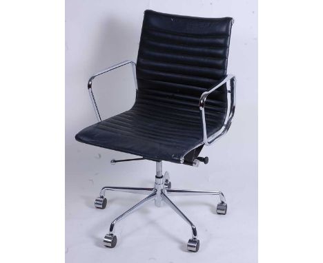 After Charles &amp; Ray Eames - a polished aluminium framed EA108 swivel desk chair, having black leather slung seat, raised 