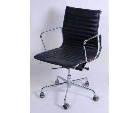 After Charles &amp; Ray Eames - a polished aluminium framed EA108 swivel desk chair, having black leather slung seat, raised 