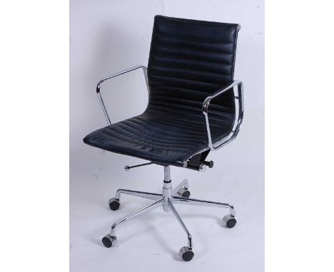 After Charles &amp; Ray Eames - a polished aluminium framed EA108 swivel desk chair, having black leather slung seat, raised 