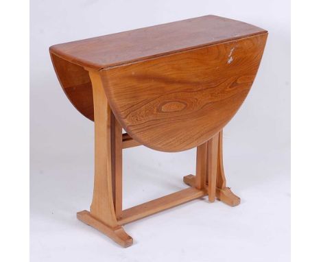 A 1960s Ercol light elm dropflap breakfast table, having opposing gateleg action, h.72cm, max length 108cm, d.84cm