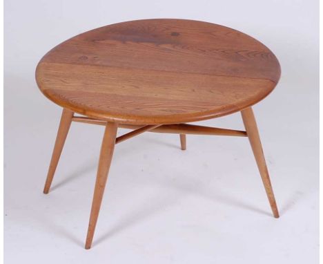 A 1960s Ercol light elm low single dropflap occasional table, having gateleg action, h.41cm, dia.60cm 