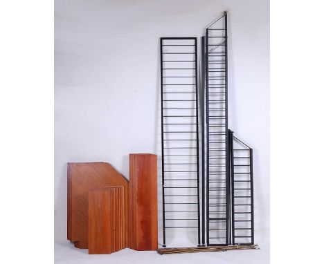 An extensive 1960s Ladderax teak and black painted metal wall shelving system, comprising; four corner shelves, four 3ft conv
