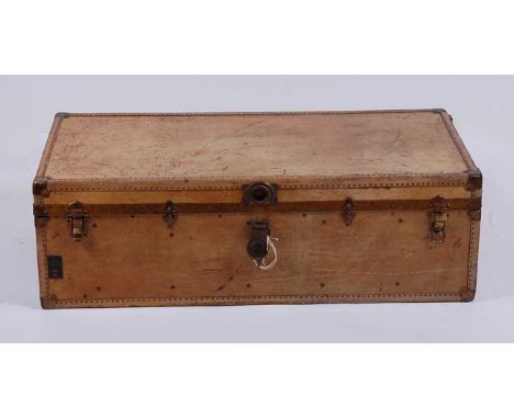 An early 20th century tan canvas, leather and metal bound fitted travelling trunk, the close nailed exterior monogrammed A.J.