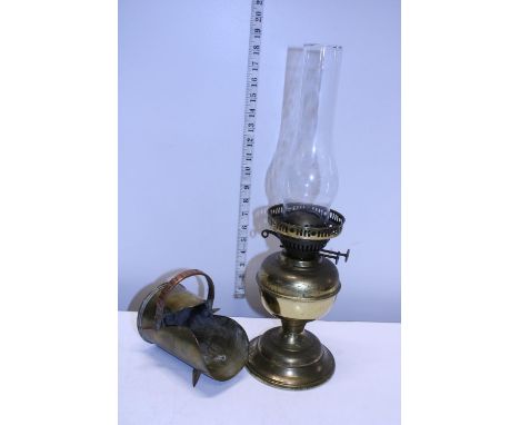 A brass based oil lamp and a WW1 trench art coal scuttle 