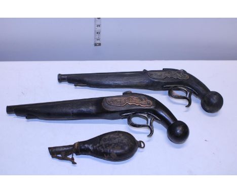 Two vintage wall hanging flintlock pistols and a antique powder flask 