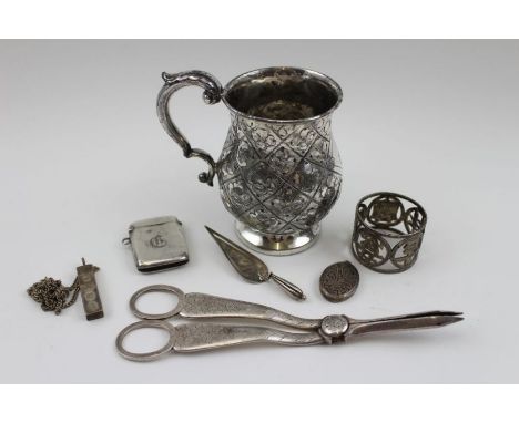 A Silver plated tankard, grape scissors, and napkin ring, with silver ingot on a chain, silver trowel form book mark, silver 