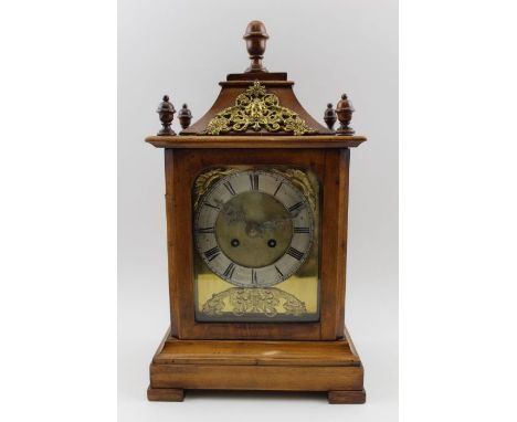 A Georgian design mahogany cased bracket clock, with turned wood and gilded brass decoration, having a silvered dial, with Ro
