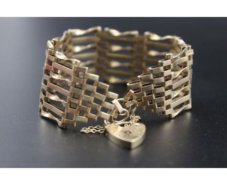 A 9ct gold gate bangle, with heart-shaped 9ct padlock clasp, 15g