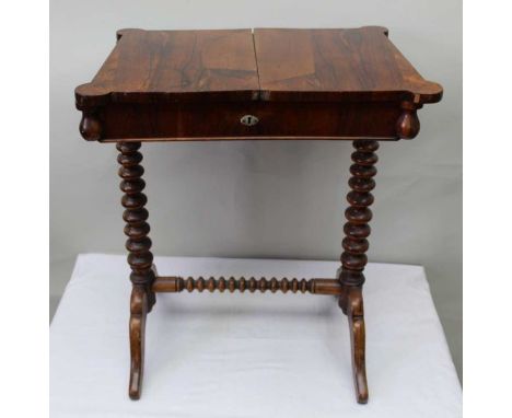 A 19th-century rosewood finished storage table, the plain top sliding out to reveal storage recess supported on bobbin turned