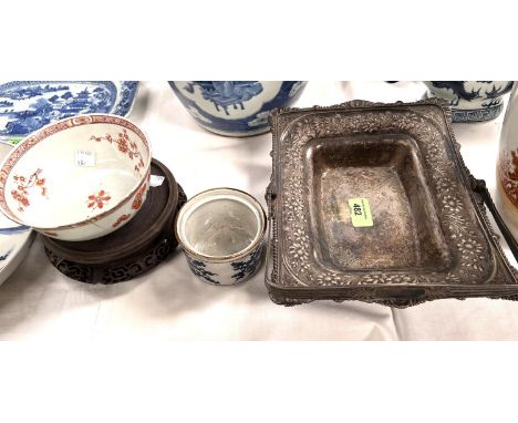 A Chinese hardwood stand (top loose); a Chinese burnt orange bowl; a silver plated dish; another item as catalogued; frits to