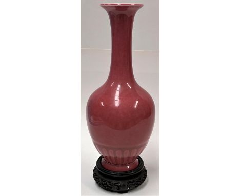 A Chinese light pink vase with lotus style decoration, 6 character mark to base, with hardwood stand, height 20.5cm 