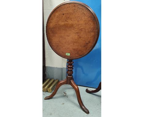 A mahogany tilt top occasional table with bobbin turned column, three splay feet with rimmed border  