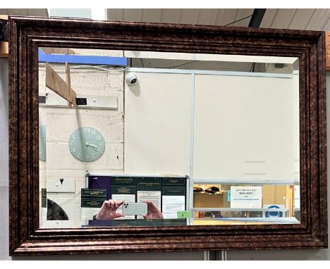 A bevelled edge wall mirror in rectangular 'antique' effect gold frame 