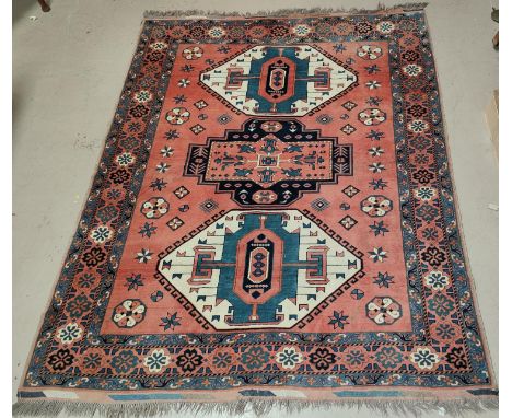 A large rust ground Turkman woollen carpet 247 x 210 cm 