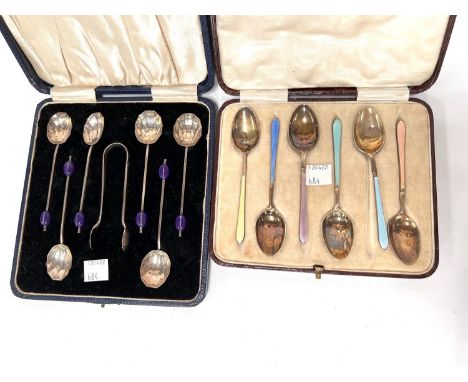 A hallmarked silver and coloured enamel set of coffee spoons,, Birmingham 1931, cased; a set of hallmarked silver bean knop c