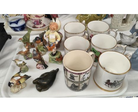 A Royal Worcester figure of a boy; a Royal Worcester bird; a selection of mugs 