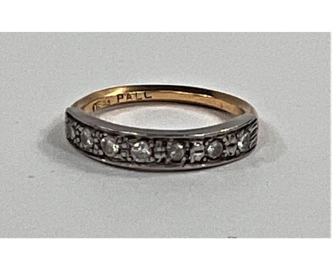 A half eternity ring set with 7 small diamonds on yellow metal shank, stamped 18ct, size K, 2.4gms 