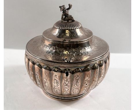 A George III silver tea caddy of melon form, engraved decoration, waisted domed lid with figural finial (unmarked) London, 18